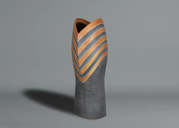Ichino Masahiko A tall and sculptural ceramic vase, the upper section with stripes in blue, dark orange, and black enamel,