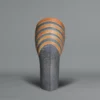 Ichino Masahiko A tall and sculptural ceramic vase, the upper section with stripes in blue, dark orange, and black enamel,