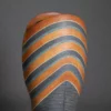 Ichino Masahiko A tall and sculptural ceramic vase, the upper section with stripes in blue, dark orange, and black enamel,